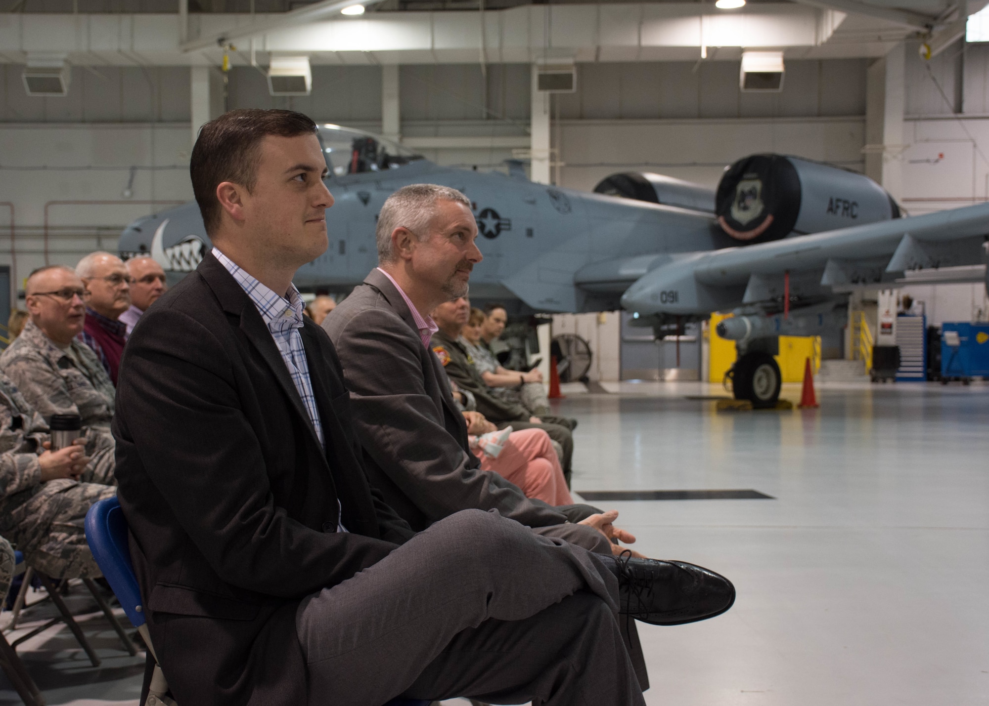 Mayor Taylor Elwell of Leeton, Mo., and BCC President Karl Kramer watch the commander's call from seats in front of an A-10 Thunderbolt II attack aircraft.