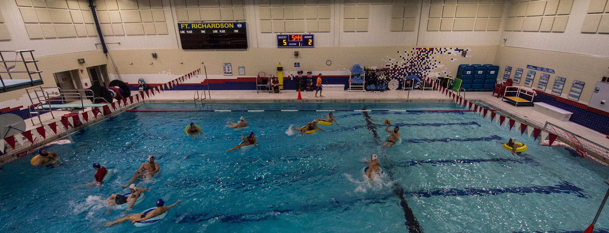 Military members and affiliates participate in an intramural game of water polo on inner tubes at the Buckner Physical Fitness Center on Joint Base Elmendorf-Richardson, Alaska, April 12, 2018. The fitness center offers a total of 18 intramural sports throughout the year, open to military members, family members, Department of Defense civilians and affiliates 18 years and older.
