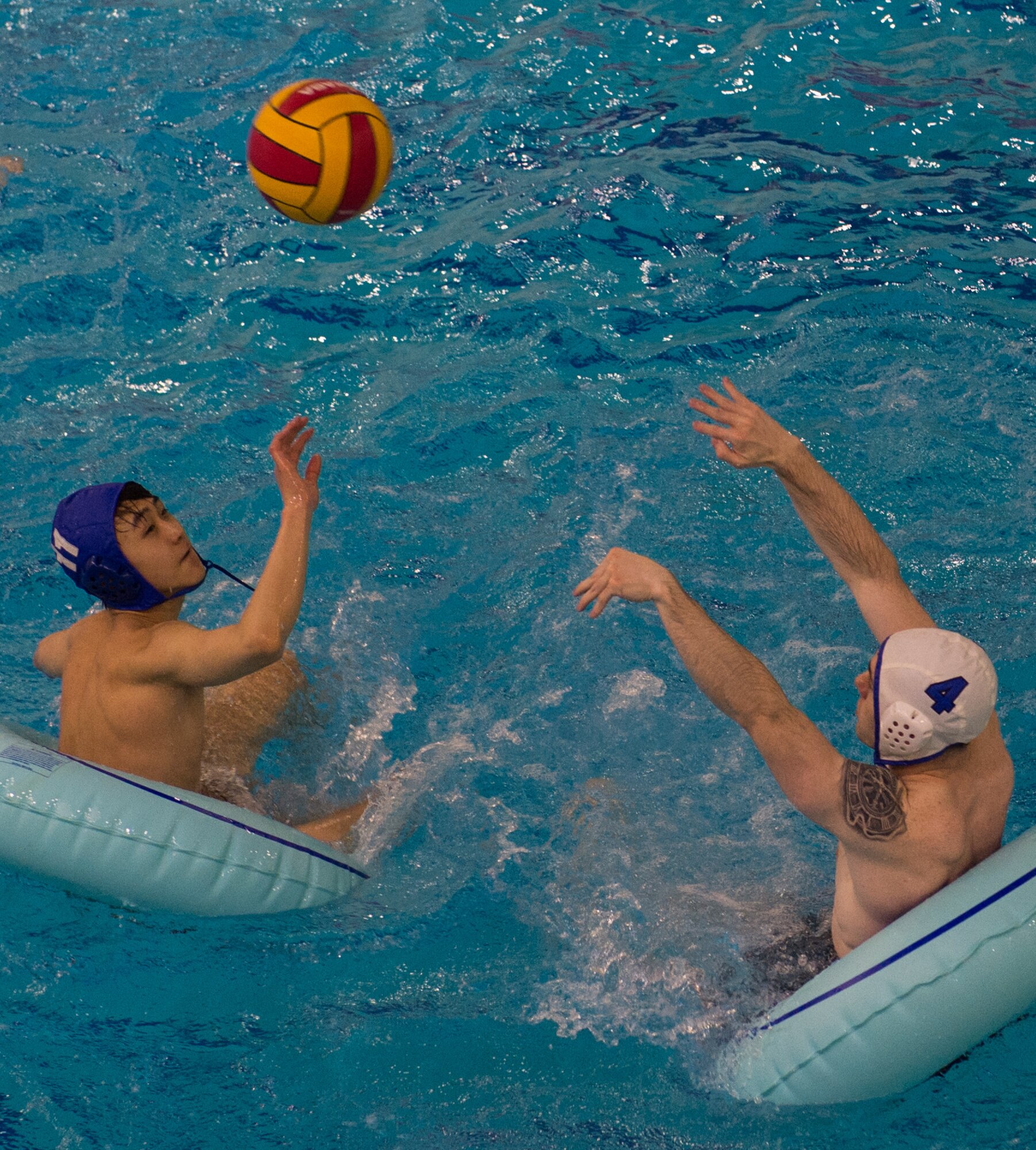 Military members and affiliates participate in an intramural game of water polo on inner tubes at the Buckner Physical Fitness Center on Joint Base Elmendorf-Richardson, Alaska, April 12, 2018. The fitness center offers a total of 18 intramural sports throughout the year, open to military members, family members, Department of Defense civilians and affiliates 18 years and older.