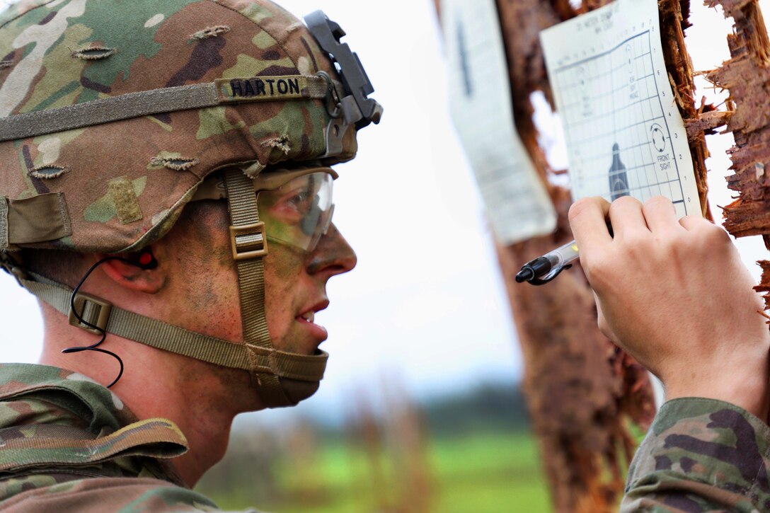 A soldier checks his target shot group.