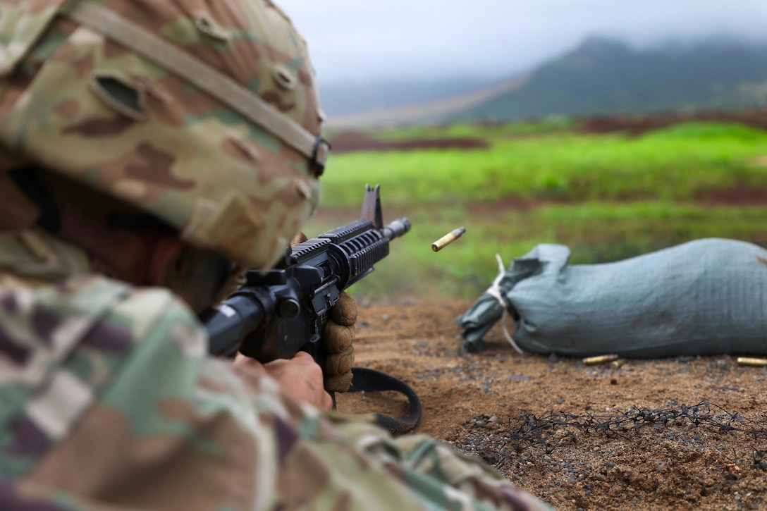 A soldier takes aim at a target.