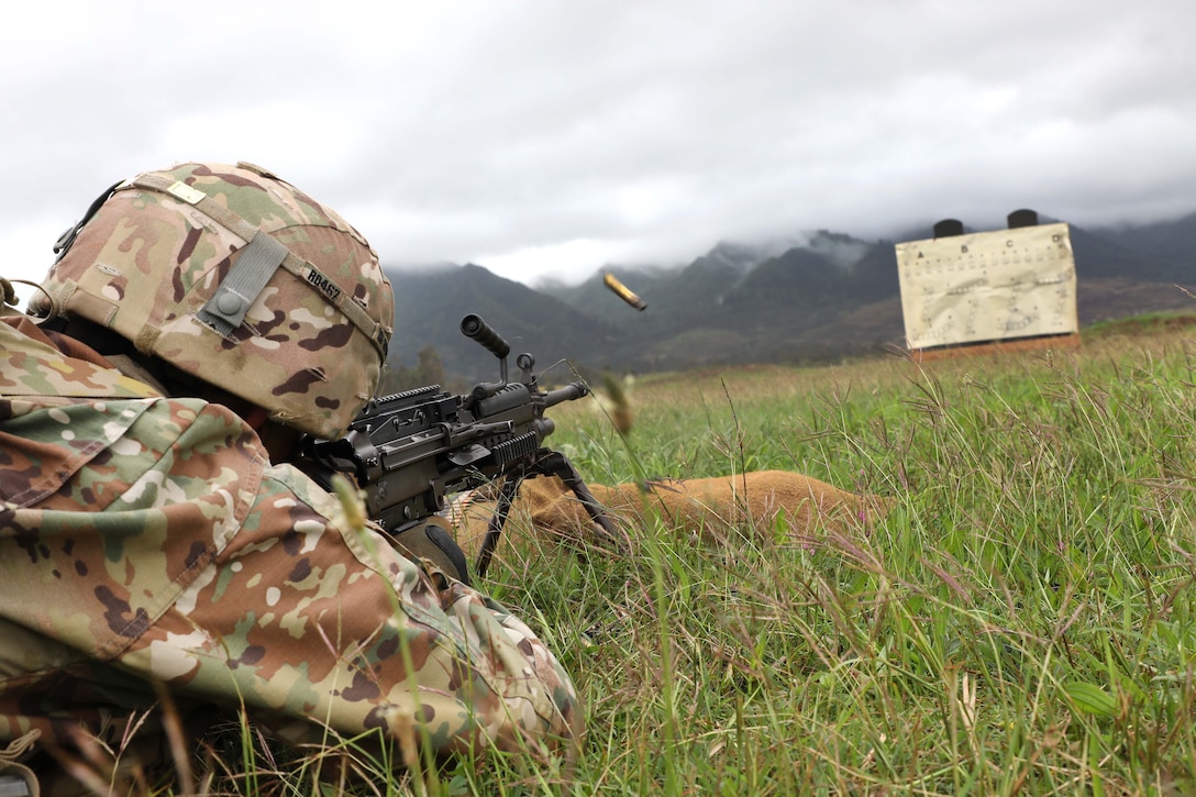 A soldier fires a machine gun during weapons qualification.