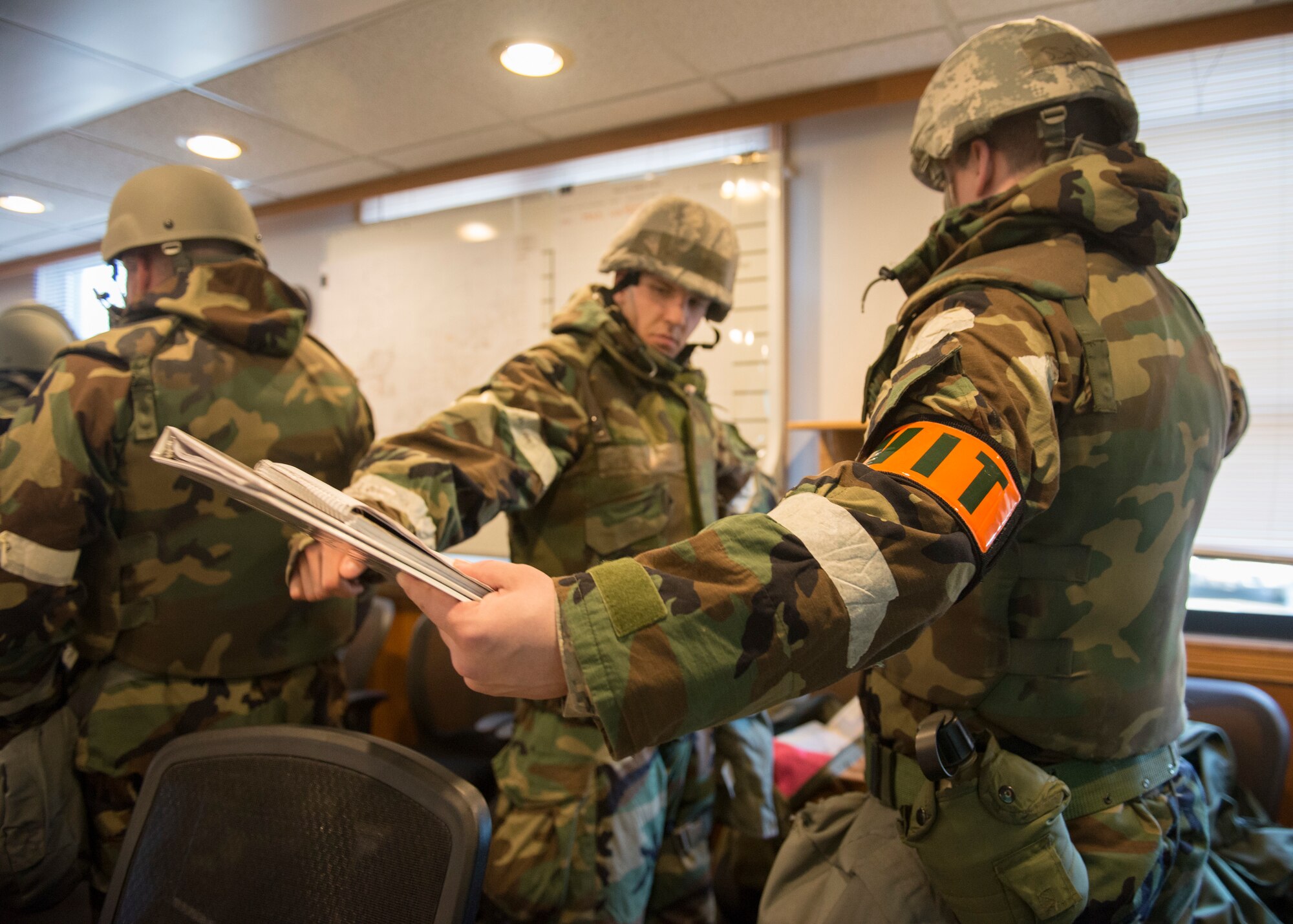 Air Force Staff Sgt. Chris Harrell, a wing inspection team member, evaluates members of the 773d Civil Engineer Squadron during exercise Polar Force 18-5 at Joint Base Elmendorf-Richardson, Alaska, April 11, 2018. Throughout the routine training exercise, Airmen donned Mission Oriented Protective Posture gear while completing various mission-related tasks to test their capabilities in challenging circumstances.