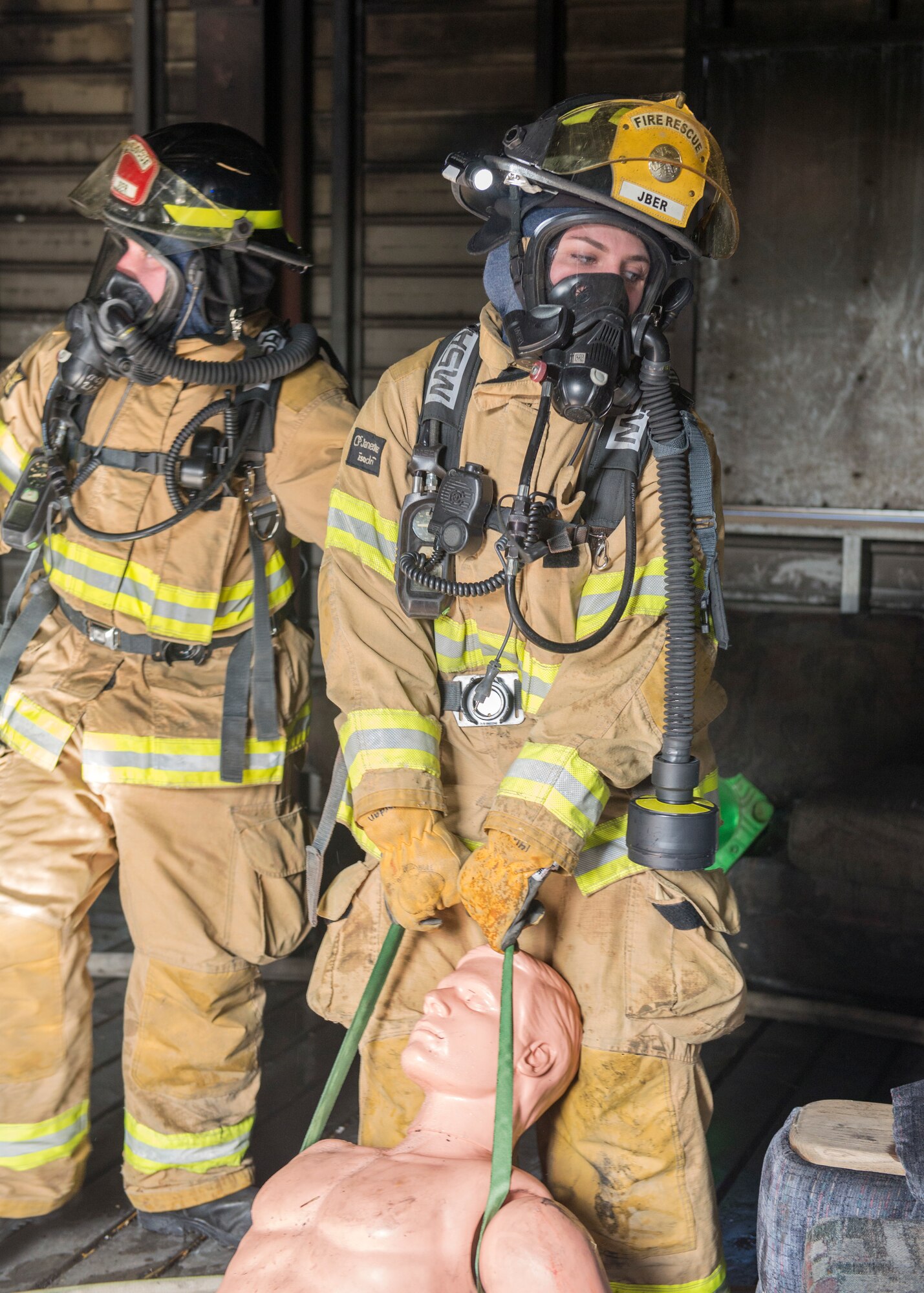 Airmen 1st Class Brittney Jordan, a 673d Civil Engineer Squadron Fire and Emergency Service driver/operator, pulls a simulated victim out of a building during exercise Polar Force 18-5 at Joint Base Elmendorf-Richardson, Alaska, April 11, 2018. Throughout the routine training exercise, Airmen donned Mission Oriented Protective Posture gear while completing various mission-related tasks to test their capabilities in challenging circumstances.