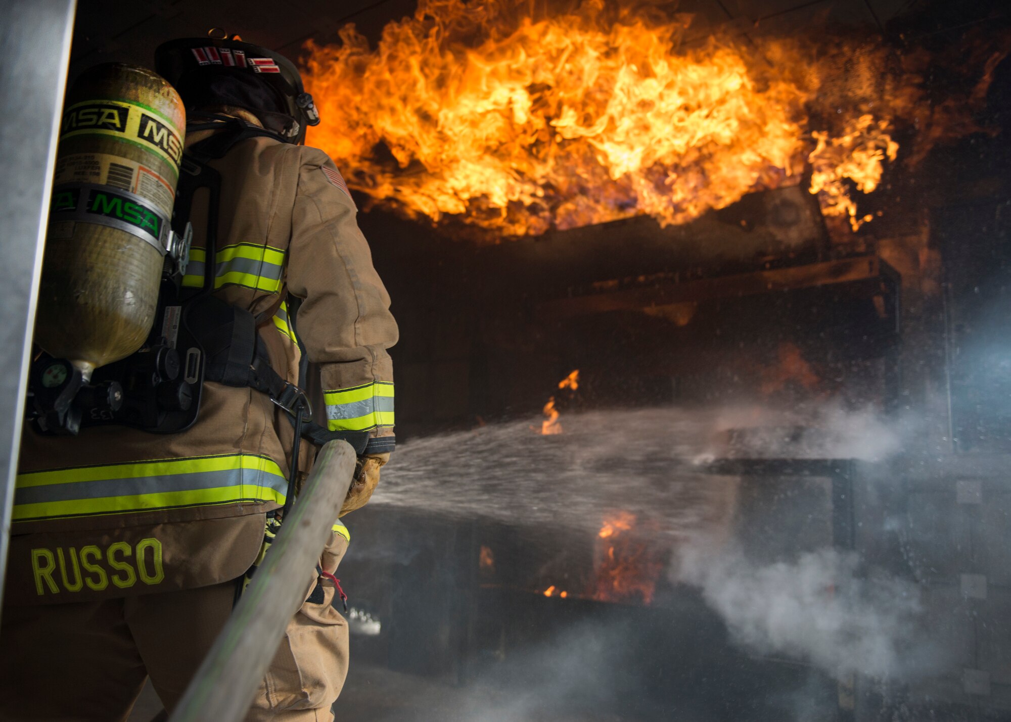 Air Force Staff Sgt. Danny Russo, a 673d Civil Engineer Squadron Fire and Emergency Service firefighter, puts out a fire during exercise Polar Force 18-5 at Joint Base Elmendorf-Richardson, Alaska, April 11, 2018. Throughout the routine training exercise, Airmen donned Mission Oriented Protective Posture gear while completing various mission-related tasks to test their capabilities in challenging circumstances.