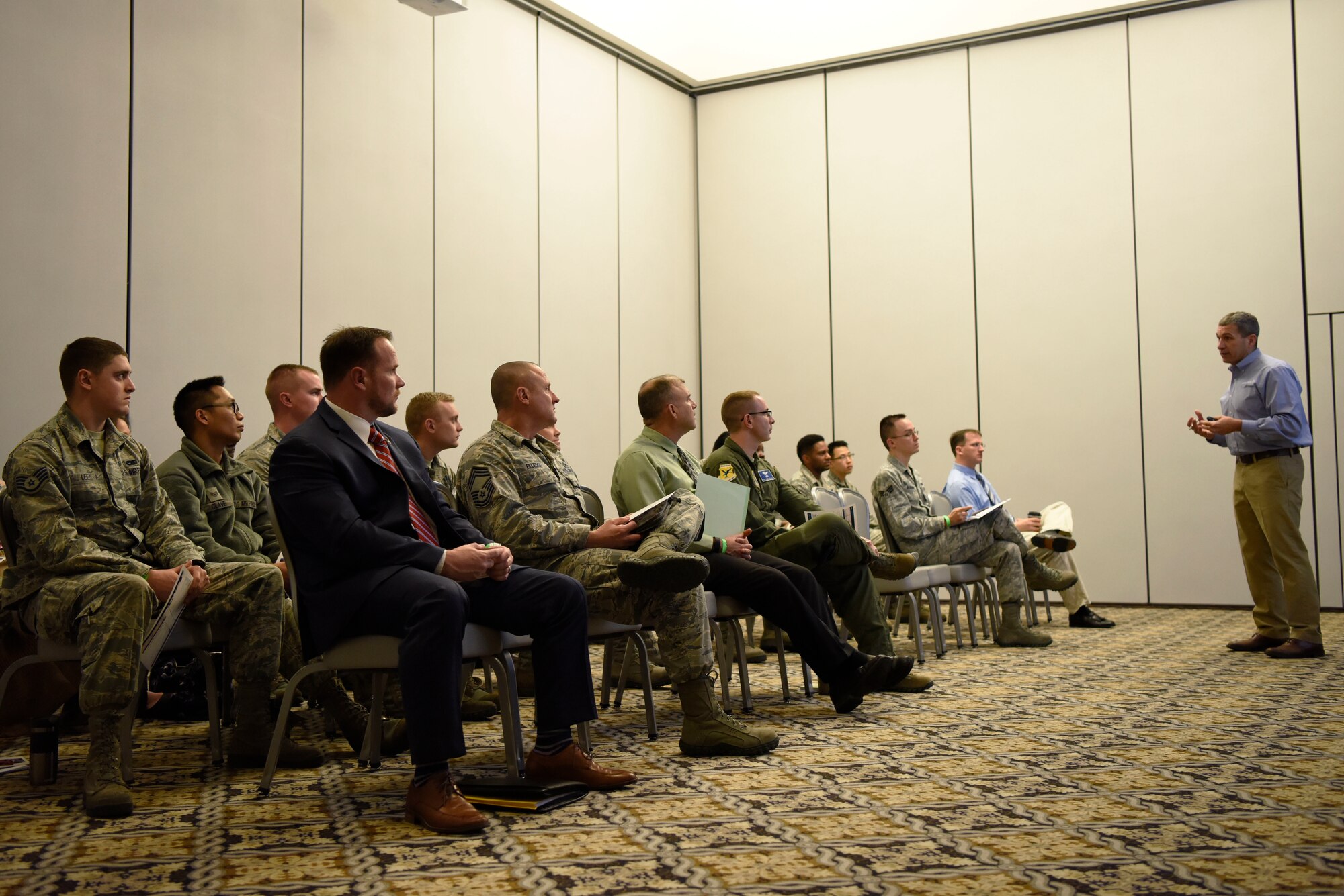 Team Dover members attend an industry brief by a representative of Lockheed Martin during the Hiring Our Heroes Military Transition Summit April 12, 2018, at Dover Air Force Base, Del. More than five different businesses provided employment briefs to the members of Dover AFB. (U.S. Air Force photo by Airman 1st Class Zoe M. Wockenfuss