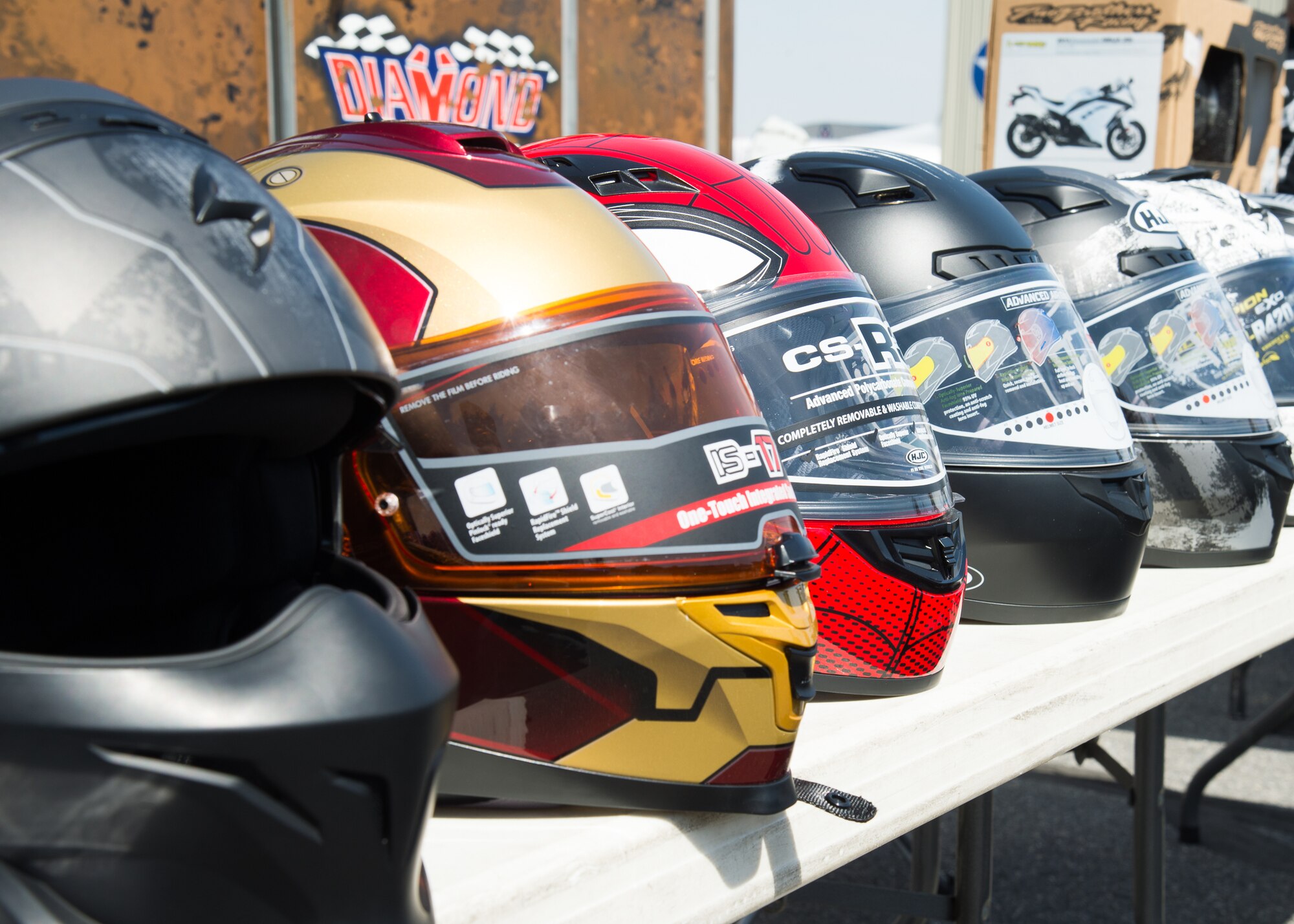 A line of safety helmets are on display during Motorcycle Safety Day April 13, 2018, at Dover Air Force Base, Del. There is no Delaware State law requiring riders to wear a helmet but Department of Defense Instructions require all military and DOD civilian personnel wear a helmet while operating or riding on a motorcycle whether on or off a DOD installation.  (U.S. Air Force photo by Mauricio Campino)