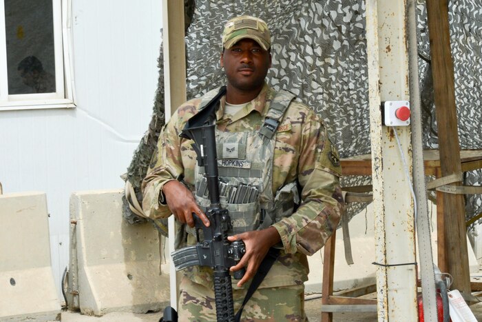 An airman holds a gun.