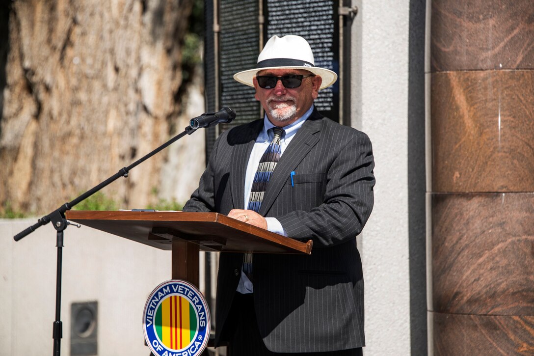 Martin Snezek addresses audience as master of ceremonies.