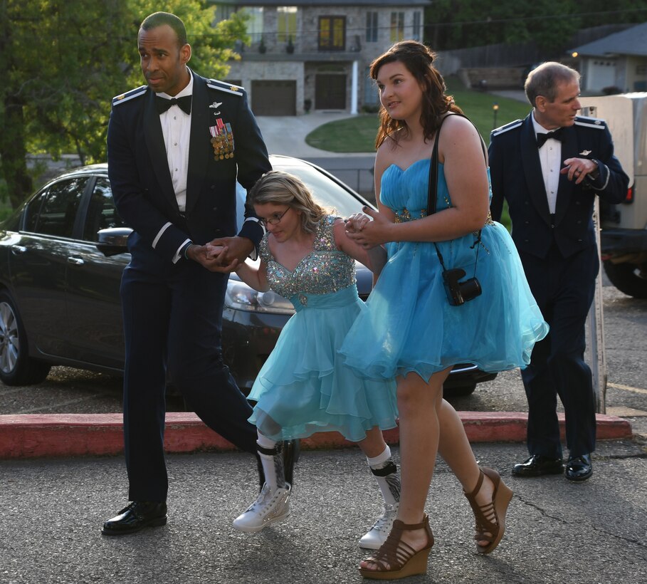 U.S. Air Force Maj. Theo Panton, assigned to the 11th Bomb Squadron at Barksdale Air Force Base, Louisiana, escorts attendees to the El Karubah Shriners’ Memories in Wonderland Ball, Shreveport, La., April 14, 2018.