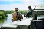 A Texas Guardsmen and a Customs and Border Patrol agent discuss the lay of the land April 10 on the shores of the Rio Grande River  in Starr County, Texas as part of the federal call-up to the Texas Mexico border. Soldiers called to duty at the border support federal partners and primarily serve in observe-and-report roles.