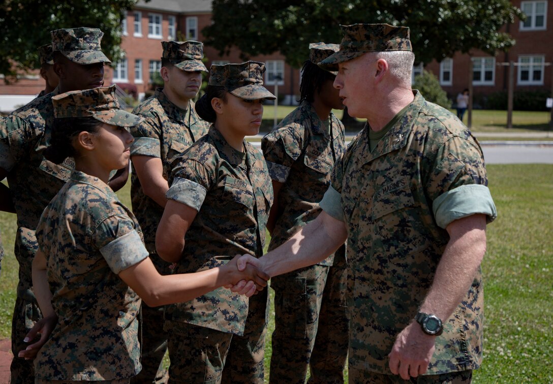 U.S. Marine Corps Col. David S. Owen, commanding officer of II Marine Expeditionary Force Information Group shakes hands with Marines with Food Service Company, II MEF Support Battalion, after being recognized as the best expeditionary food service in the Marine Corps at Camp Lejeune, N.C., April 13, 2018.