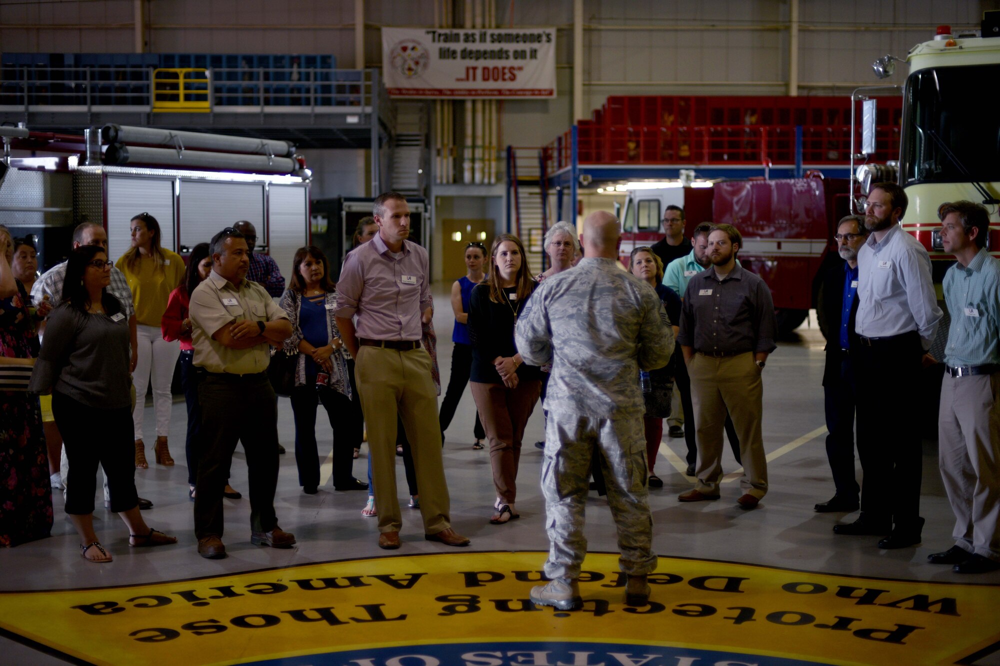 U.S. Air Force Master Sgt. Cory Bowers, 312th Training Squadron Advance Courses chief, briefs the Leadership San Angelo members on the Louis F. Garland Department of Defense Fire Academy in the High Bay on Goodfellow Air Force Base, Texas, April 12, 2018. The academy was one of multiple locations the LSA visited. (U.S. Air Force photo by Senior Airman Randall Moose/Released)