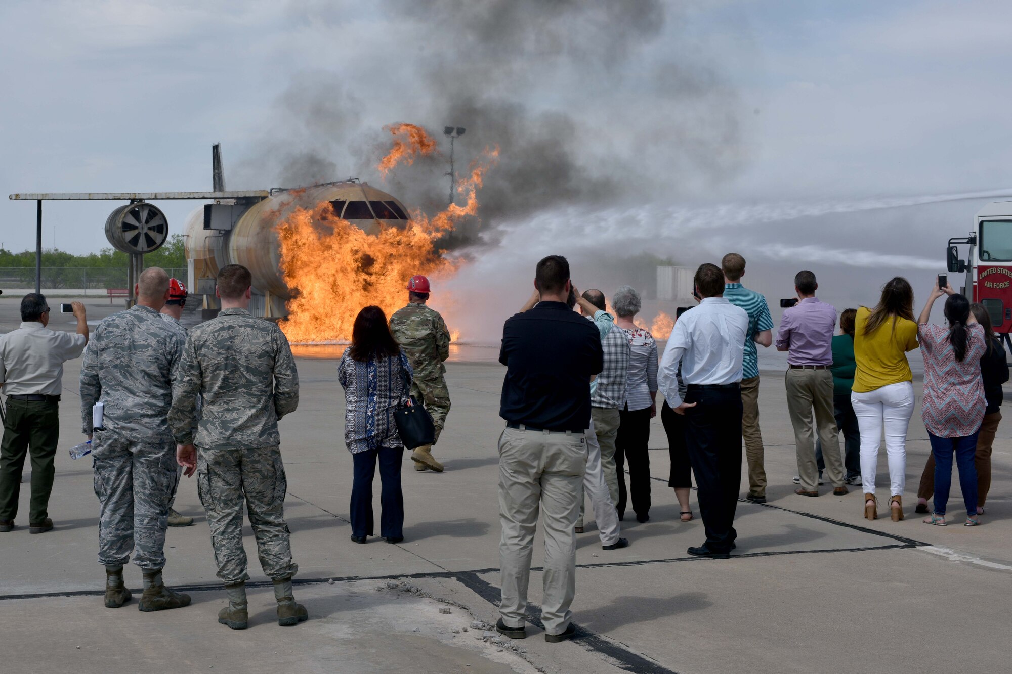 Members from Leadership San Angelo watch a firefighting demonstration at the Louis F. Garland Department of Defense Fire Academy on Goodfellow Air Force Base, Texas, April 12, 2018. Trainees use the controlled fires as a hands-on training experience. (U.S. Air Force photo by Senior Airman Randall Moose/Released)