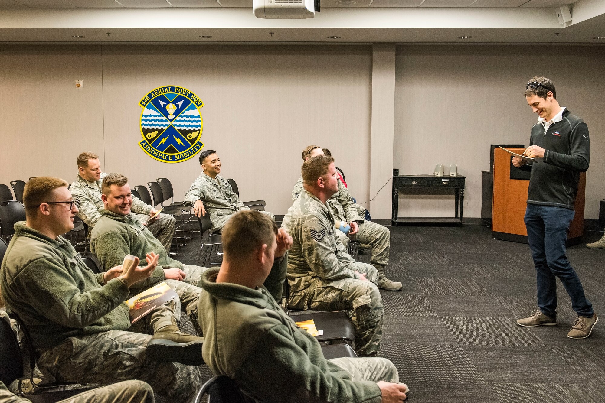 Joey Logano, driver of the No. 22 Ford in the Monster Energy NASCAR Cup Series, autographs “hero” cards and answers questions while visiting with members of the 436th Aerial Port Squadron April 11, 2018, at Dover Air Force Base, Del. Logano met numerous “Port Dawgs” during his brief visit to the Super Port. (U.S. Air Force photo by Roland Balik)