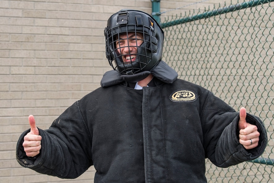 Joey Logano, driver of the No. 22 Ford in the Monster Energy NASCAR Cup Series, gives the “thumbs up” sign as he prepares to enter the 436th Security Forces Squadron military working dog training area April 11, 2018, at Dover Air Force Base, Del. Logano donned the protective bite suit in preparation for a demonstration involving him and Karlo, an 80-pound Belgian Malinois. (U.S. Air Force photo by Roland Balik)