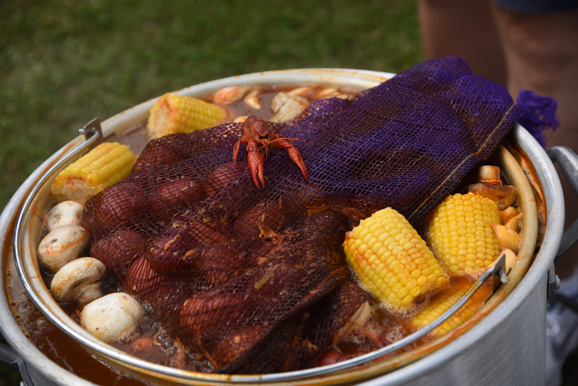A pot of boiled crawfish and the ‘fixins’ soak in seasonings during the 6th Annual Bay Breeze Crawfish Cook-Off at the Bay Breeze Event Center at Keesler Air Force Base, Mississippi, April 13, 2018. The “Craw-Fish Pot-Nahs” won first place overall and a free entry into the 26th Annual Mississippi Coast Coliseum Crawfish Festival Cook-Off. Over 800 Keesler personnel attended the event. (U.S. Air Force photo by Kemberly Groue)