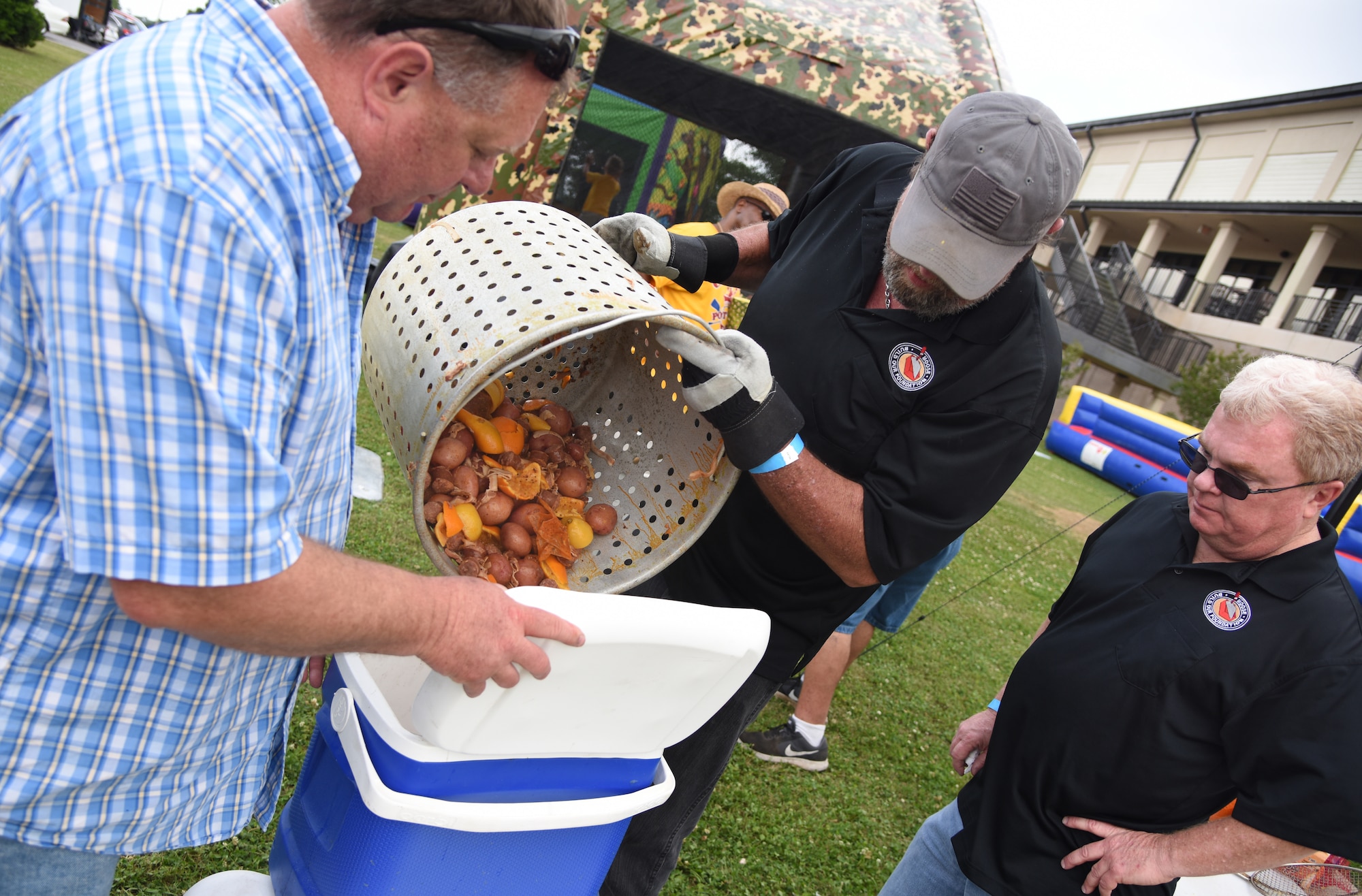 “Crawfish Daddies” team members, Rob Erman, 2nd Air Force program manager, Ronald McCarty and Brett Long, 81st Infrastructure Division housing chief, dump the ‘fixins’ from their crawfish boil into a cooler during the 6th Annual Bay Breeze Crawfish Cook-Off at the Bay Breeze Event Center at Keesler Air Force Base, Mississippi, April 13, 2018. The “Craw-Fish Pot-Nahs” won first place overall and a free entry into the 26th Annual Mississippi Coast Coliseum Crawfish Festival Cook-Off. Over 800 Keesler personnel attended the event and almost 1700 pounds of crawfish was distributed. (U.S. Air Force photo by Kemberly Groue)
