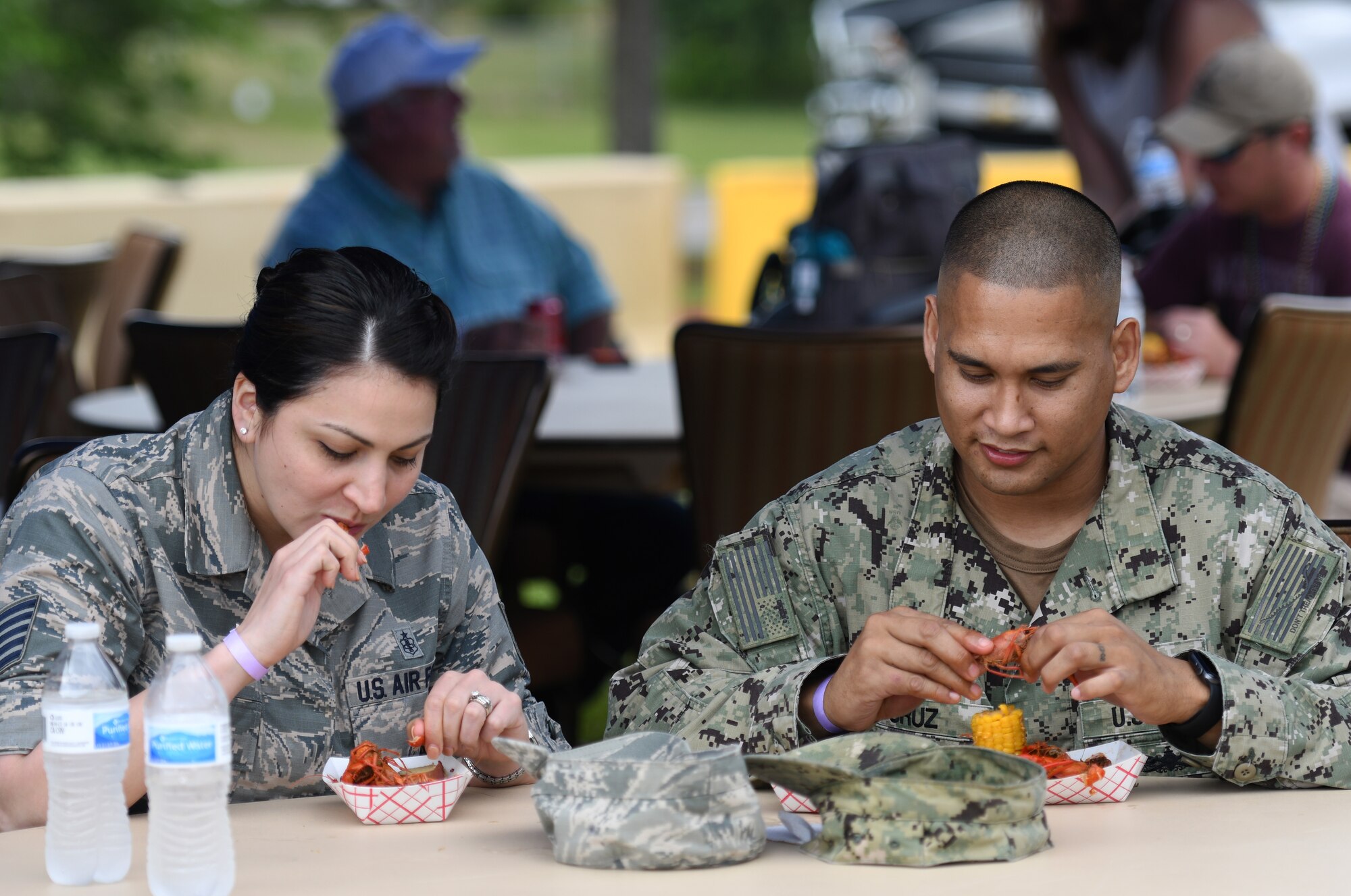 U.S. Air Force Tech. Sgt. Cassandra Cruz, 81st Force Support Squadron Airmen Leadership School instructor, and U.S. Navy Chief Gunners Mate Kiko Cruz, Navy Recruiting Command naval officer recruiter, District New Orleans, Louisiana, eat crawfish during the 6th Annual Bay Breeze Crawfish Cook-Off at the Bay Breeze Event Center at Keesler Air Force Base, Mississippi, April 13, 2018. The “Craw-Fish Pot-Nahs” won first place overall and a free entry into the 26th Annual Mississippi Coast Coliseum Crawfish Festival Cook-Off. (U.S. Air Force photo by Kemberly Groue)