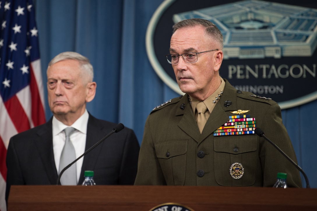 Two defense leaders stand behind a podium.