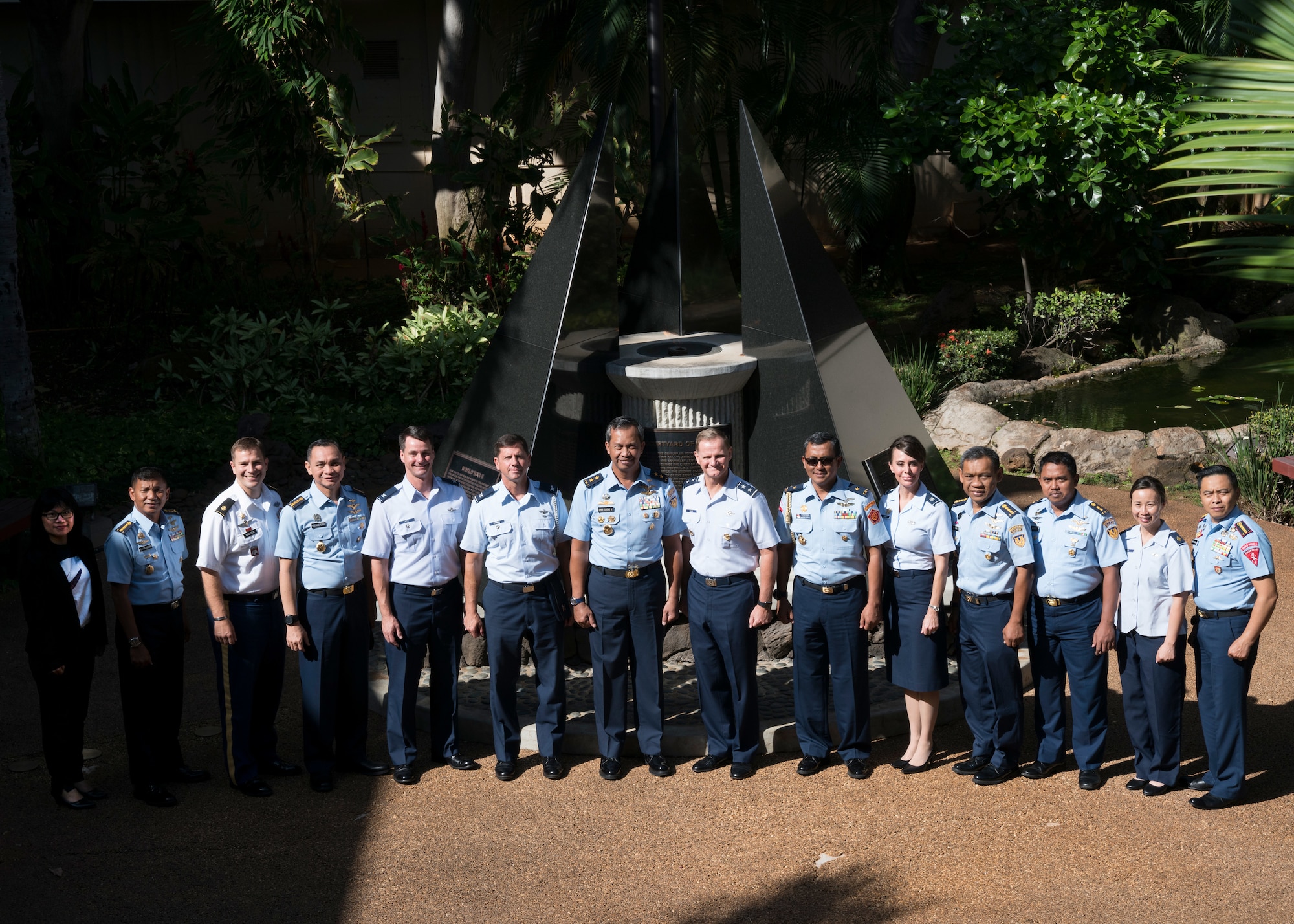 (Center Right) U.S. Air Force Maj. Gen Russell Mack, Pacific Air Forces (PACAF) deputy commander, (Center Left) Indonesian Air Vice Marshal Umar Sugeng Haryono and the attendees of the U.S. and Indonesian Airman-to-Airman (A2A) talks pose for a group photo in the Courtyard of Heroes at Joint Base Pearl Harbor-Hickam, Hawaii, April 11, 2018. PACAF senior leaders hosted Indonesian air force leaders to discuss common regional security challenges. The A2A talks are intended to increase cooperation with our allies and partners. (U.S. Air Force Photo/Staff Sgt. Daniel Robles)