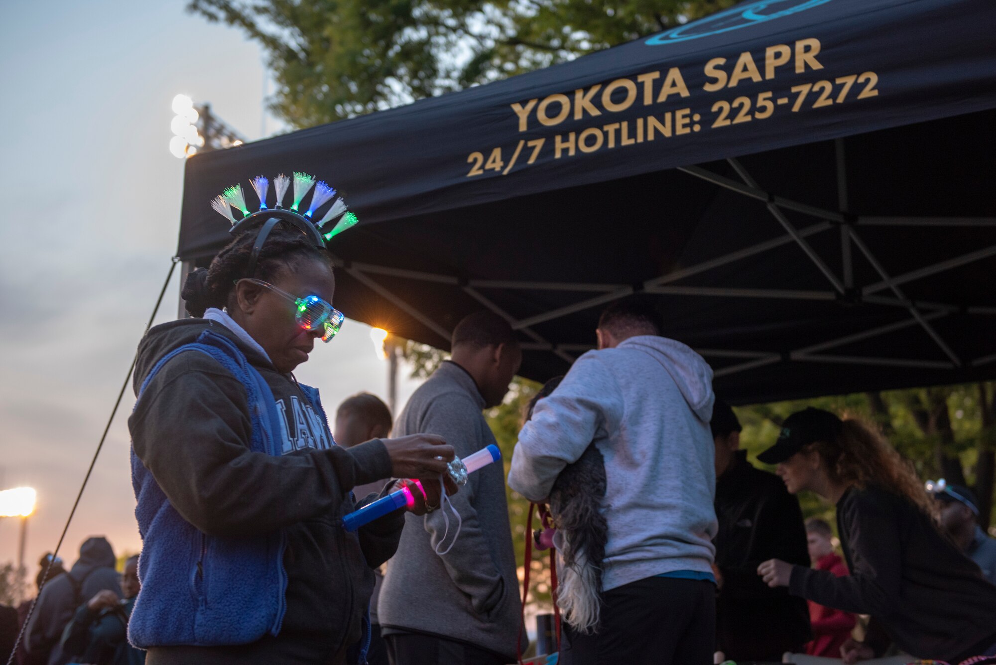 A participant prepares their glow stick for the Light the Night 5k at Yokota Air Base, Japan, April 13, 2018.