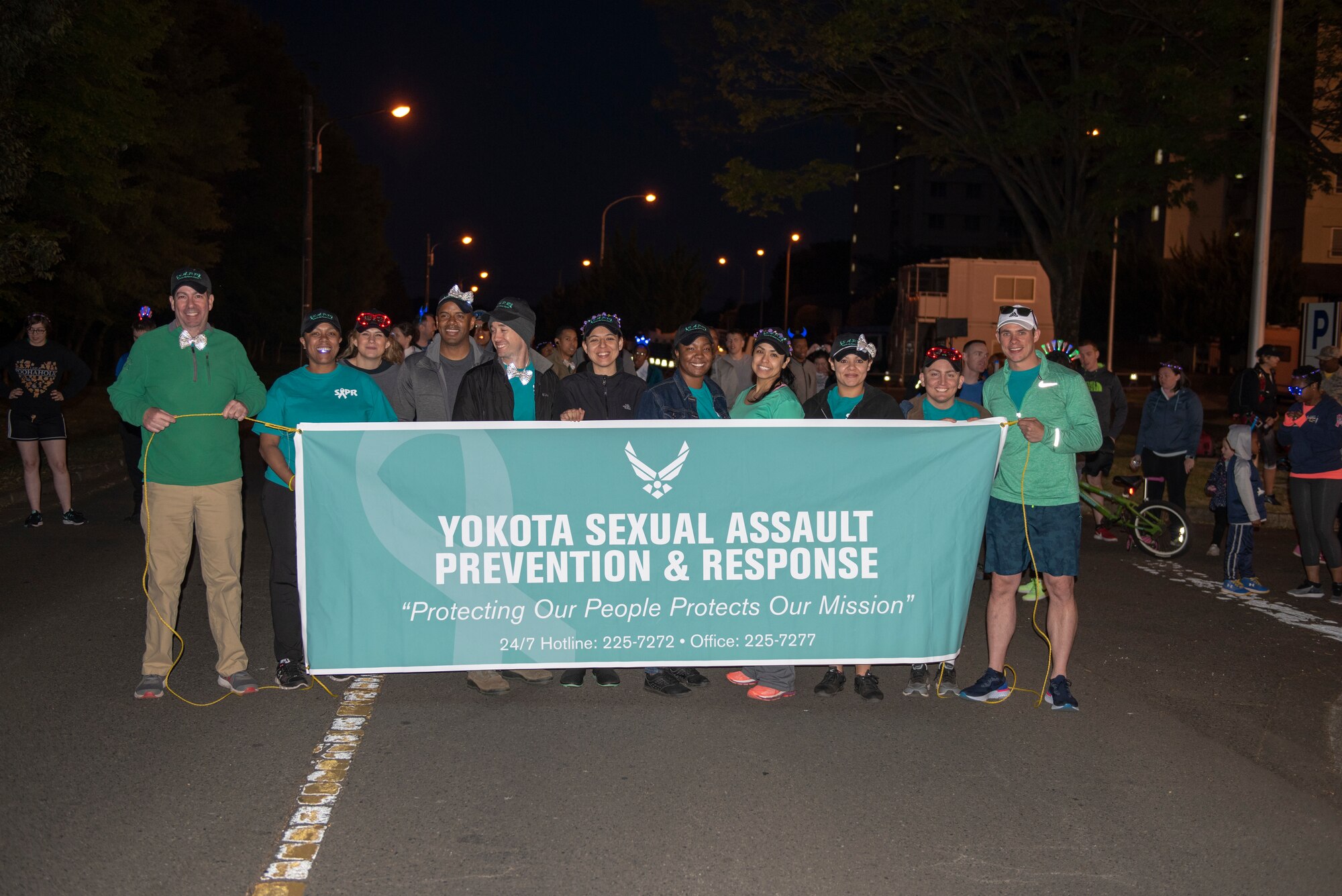 Members of the Sexual Assault Awareness & Prevention office and base Victim Advocates pose for a photo prior to the Light the Night 5k at Yokota Air Base, Japan, April 13, 2018.
