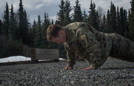 Spc. Eric Haugh, a sniper assigned to the 1st Squadron, 40th Cavalry Regiment (Airborne), 4th Infantry Brigade Combat Team (Airborne), 25th Infantry Division, U.S. Army Alaska, performs a push-up during a stress shooting exercise at Joint Base Elmendorf-Richardson, Alaska, April 11, 2018. Leadership at Forward Operating Base Gardez, Afghanistan, hand-picked Haugh to represent the U.S. in the 10th Annual Czech Republic World Sniper Competition April 23 through 27. Stress shooting drills incorporate physical training to increase heart rate and breathing and make holding steady difficult during shooting, simulating a stressed environment.