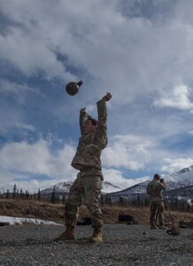 Spc. Arturo Dominguez, a sniper assigned to the 1st Squadron, 40th Cavalry Regiment (Airborne), 4th Infantry Brigade Combat Team (Airborne), 25th Infantry Division, U.S. Army Alaska, throws kettle bells into the air during a stress shooting exercise at Joint Base Elmendorf-Richardson, Alaska, April 11, 2018. Leadership at Forward Operating Base Gardez, Afghanistan, hand-picked Dominguez to represent the U.S. in the 10th Annual Czech Republic World Sniper Competition April 23 through 27. Stress shooting drills incorporate physical training to increase heart rate and breathing and make holding steady difficult during shooting, simulating a stressed environment.