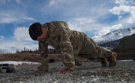 Spc. Arturo Dominguez, a sniper assigned to the 1st Squadron, 40th Cavalry Regiment (Airborne), 4th Infantry Brigade Combat Team (Airborne), 25th Infantry Division, U.S. Army Alaska, performs a push-up during a stress shooting exercise at Joint Base Elmendorf-Richardson, Alaska, April 11, 2018. Leadership at Forward Operating Base Gardez, Afghanistan, hand-picked Dominguez to represent the U.S. in the 10th Annual Czech Republic World Sniper Competition April 23 through 27. Stress shooting drills incorporate physical training to increase heart rate and breathing and make holding steady difficult during shooting, simulating a stressed environment.