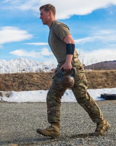 Spc. Eric Haugh, a sniper assigned to the 1st Squadron, 40th Cavalry Regiment (Airborne), 4th Infantry Brigade Combat Team (Airborne), 25th Infantry Division, U.S. Army Alaska, sprints with kettle bells during a stress shooting exercise at Joint Base Elmendorf-Richardson, Alaska, April 11, 2018. Leadership at Forward Operating Base Gardez, Afghanistan, hand-picked Haugh to represent the U.S. in the 10th Annual Czech Republic World Sniper Competition April 23 through 27. Stress shooting drills incorporate physical training to increase heart rate and breathing and make holding steady difficult during shooting, simulating a stressed environment.