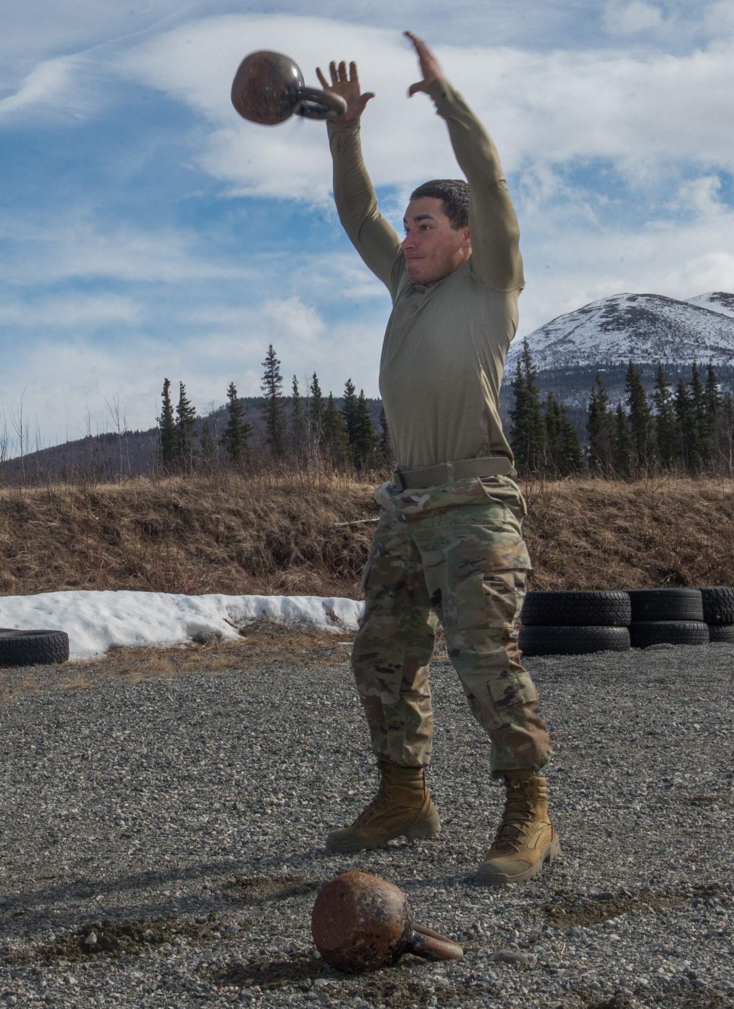 Spc. Eric Haugh, a sniper assigned to the 1st Squadron, 40th Cavalry Regiment (Airborne), 4th Infantry Brigade Combat Team (Airborne), 25th Infantry Division, U.S. Army Alaska, sprints with kettle bells during a stress shooting exercise at Joint Base Elmendorf-Richardson, Alaska, April 11, 2018. Leadership at Forward Operating Base Gardez, Afghanistan, hand-picked Haugh to represent the U.S. in the 10th Annual Czech Republic World Sniper Competition April 23 through 27. Stress shooting drills incorporate physical training to increase heart rate and breathing and make holding steady difficult during shooting, simulating a stressed environment.
