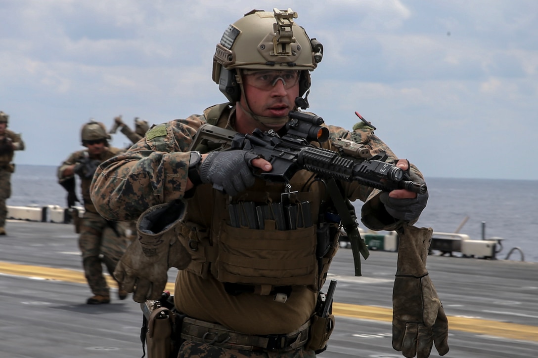 Recon Marines fast rope from an MH-60S aboard the USS Wasp