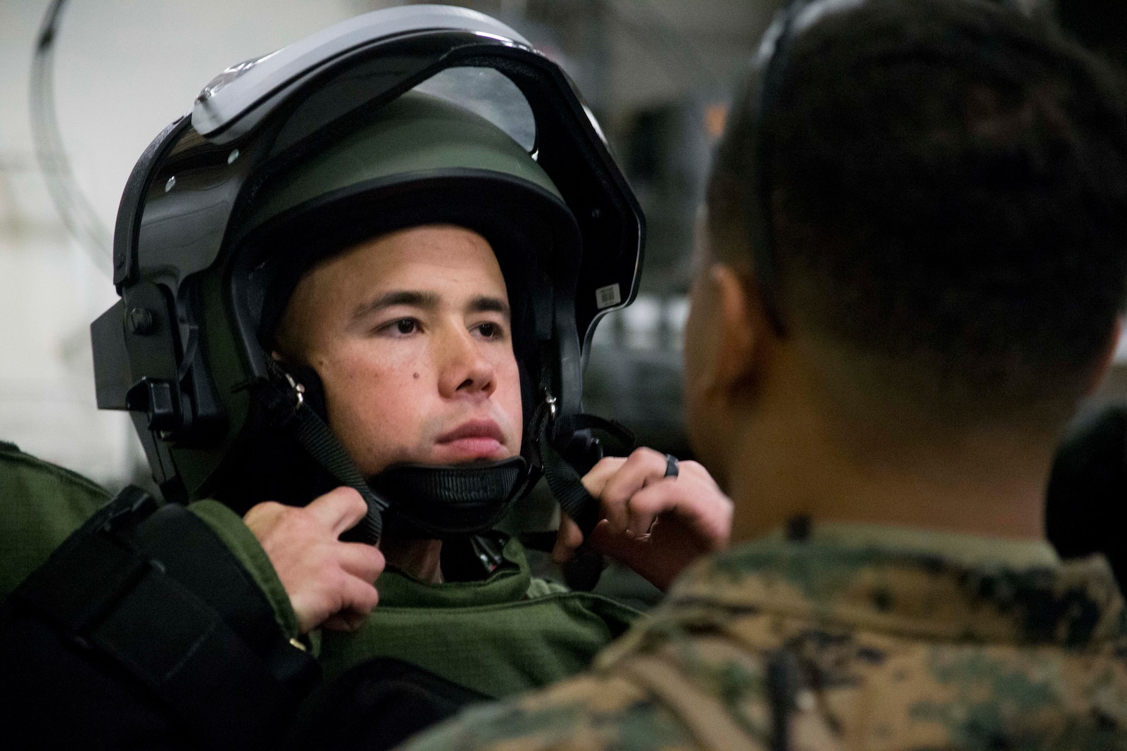 CWO2 Samuel Beltram, an Explosive Ordnance Disposal officer with Combat Logistics Battalion 31, 31st Marine Expeditionary Unit, adjusts his helmet as he prepares for a mock EOD sweep aboard the USS Wasp (LHD-1) while underway in the Pacific Ocean, April 3, 2018.