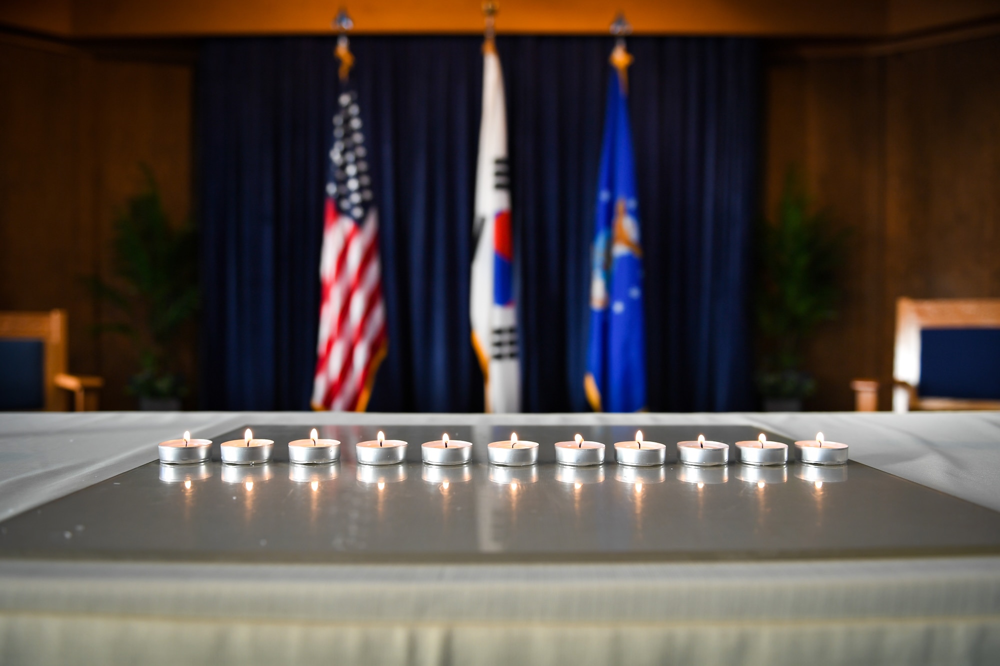 Eleven candles are lit and displayed during a remembrance service on Osan Air Base, April 12, 2018. The candles represent 11 million people murdered by Germany's Nazi regime between 1933 and 1945. From April 9 to 13, 2018, the base hosted an opening ceremony, a film screening of Conspiracy, a 5K run, and a remembrance service held at the chapel (U.S. Air Force photo by Staff Sgt. Benjamin Raughton)