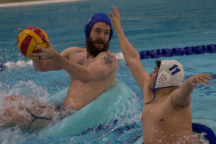 Military members and affiliates participate in an intramural game of water polo on inner tubes at the Buckner Physical Fitness Center on Joint Base Elmendorf-Richardson, Alaska, April 12, 2018. The fitness center offers a total of 18 intramural sports throughout the year, open to military members, family members, Department of Defense civilians and affiliates 18 years and older.