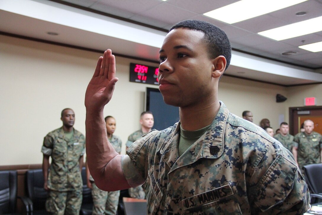 U.S. ARMY GARRISON YONGSAN – Sgt. Justin K. McBeth, U.S. Marine Corps Forces Korea G3 training chief, swears in during his reenlistment ceremony here, April 12. McBeth departed for Rutgers University after Marine Corps Recruiting Command selected him for the Marine Enlisted Commissioning Education Program.  (Official U.S. Marine Corps photo by Sgt. Nathaniel Hanscom/Released)