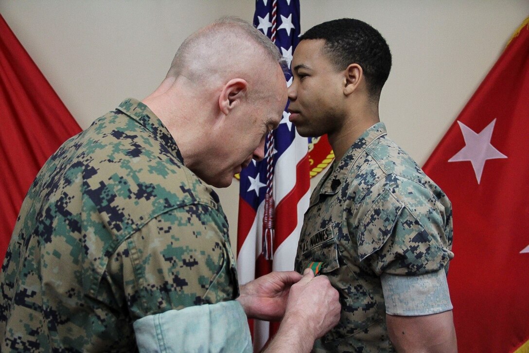 U.S. ARMY GARRISON YONGSAN – Maj. Gen. Patrick J. Hermesmann (Left), commander of U.S. Marine Corps Forces Korea, awards Sgt. Justin K. McBeth, MARFORK G3 training chief, the Navy and Marine Corps Achievement Medal here, April 12. McBeth departed for Rutgers University after Marine Corps Recruiting Command selected him for the Marine Enlisted Commissioning Education Program.  (Official U.S. Marine Corps photo by Sgt. Nathaniel Hanscom/Released)