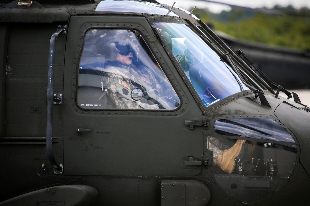 Army pilots prepare their UH-60L Black Hawk helicopter.