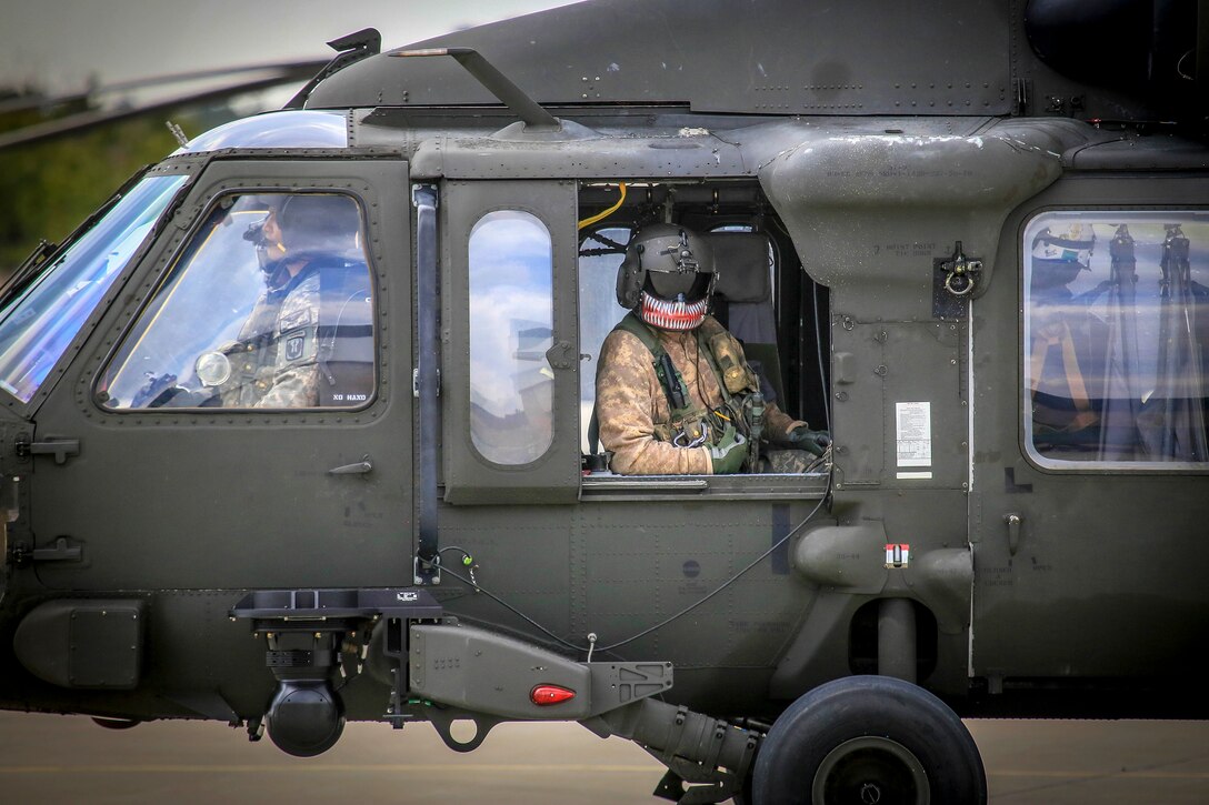 Army crew chief makes final checks for his helicopter.