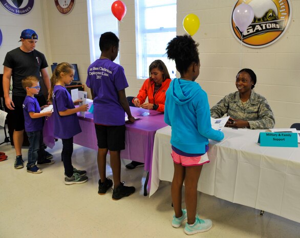 Children process through the deployment line with different base agencies during a youth deployment line at Joint Base Charleston – Weapons Station, S.C., Nov. 4, 2017.