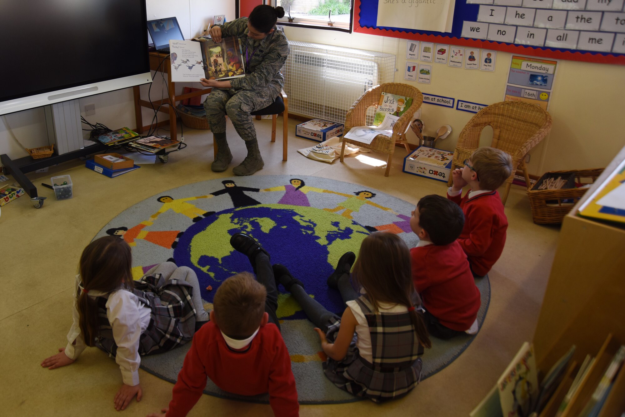Airman 1st Class Xzandra Bradley, 48th Logistics Readiness Squadron material management journeyman, reads to a group of children at Brookes Cambridge school in Bury St. Edmunds, England, April 17, 2018. Although mostly comprised of British students, schools like Brookes Cambridge are also sometimes host to children of visiting U.S. service members. (U.S. Air Force photo/Senior Airman Abby L. Finkel)