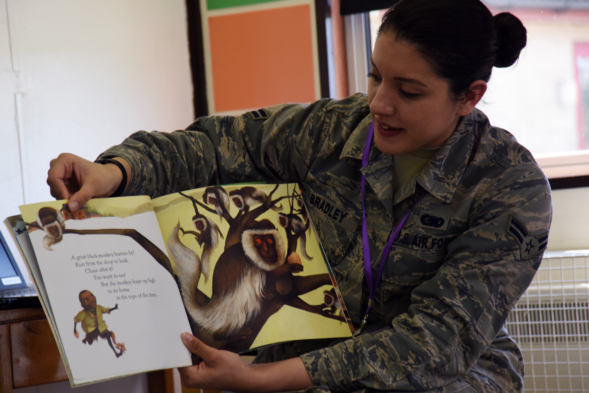 Airman 1st Class Xzandra Bradley, 48th Logistics Readiness Squadron material management journeyman, reads to a group of children at Brookes Cambridge school in Bury St. Edmunds, England, April 17, 2018. Six Liberty Wing Airmen volunteered to spend part of an afternoon reading to students as well as answering questions about what it's like to be a military member. (U.S. Air Force photo/Senior Airman Abby L. Finkel)