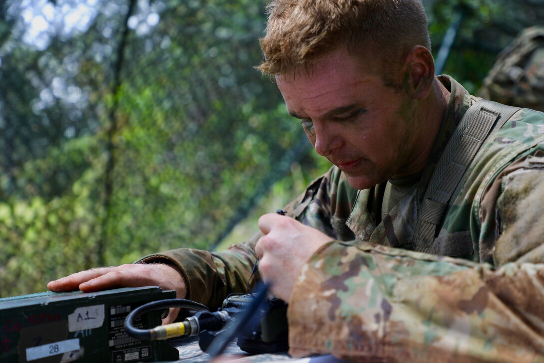 A soldier tests equipment during training.