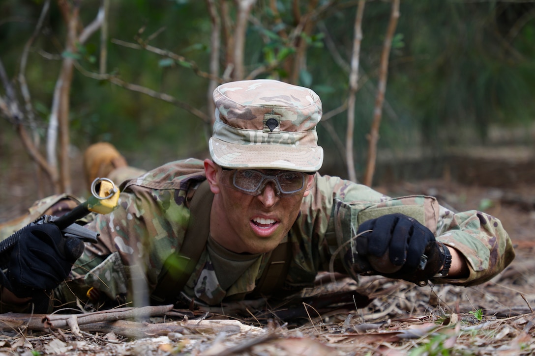 A soldier performs the low crawl.