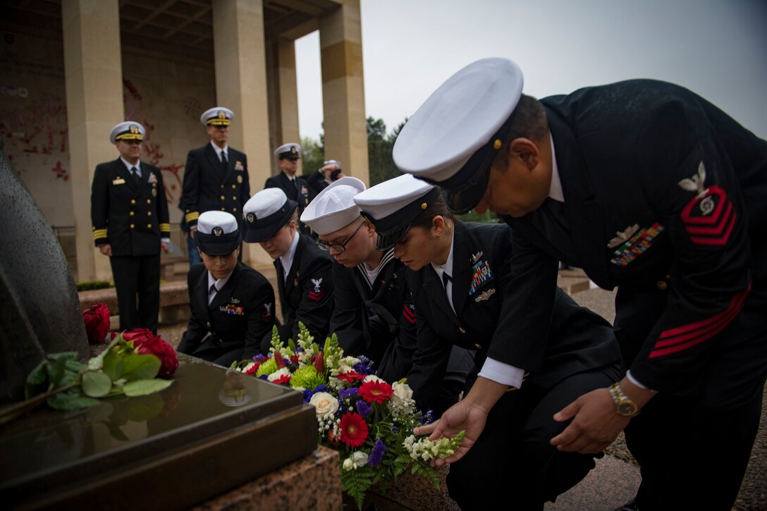 Sailors place wreaths at a memorial to U.S soldiers in Normandy, France.