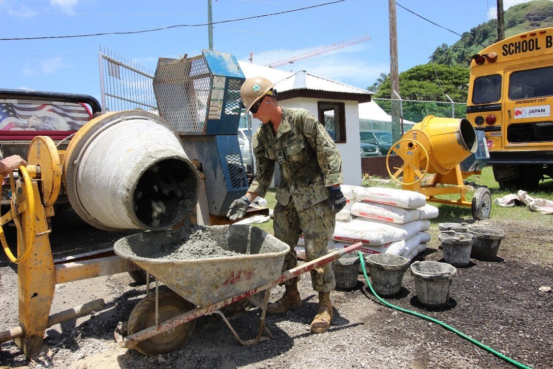 Navy seaman collects the first batch of concrete for testing.