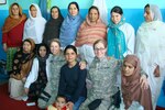 Air Force doctor poses with Afghan women.