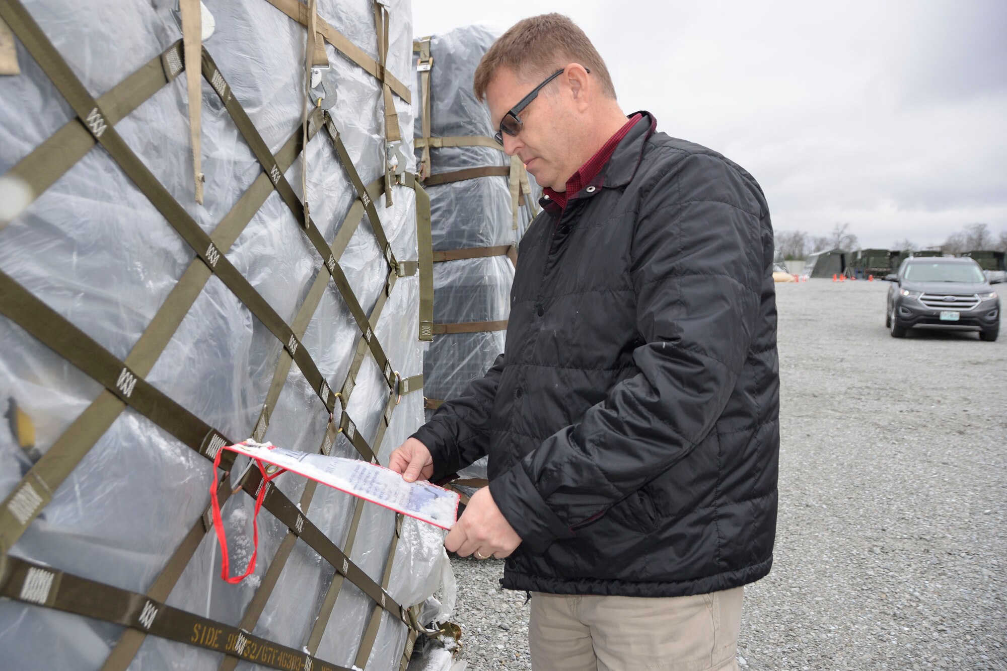 Jeff Brandenburg, chief, Air Forces Northern Medical Plans and Logistics, looks over a packing list on a pallet of medical supplies prior to the start of an Expeditionary Medical Support field confirmation exercise here April 16.