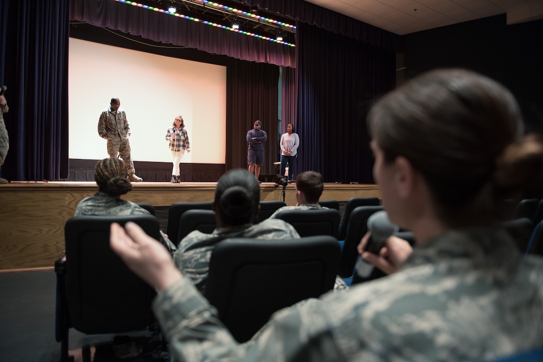 An audience member asks actors questions after the performance of “Same Script, Different Cast”, by the Sexual Assault Theater Group at Joint Base Langley-Eustis, Va., April 13, 2018. The actors answered audience questions while remaining in character, to give the audience a look into how the portrayed characters think. (U.S. Air Force photo by Staff Sgt. Carlin Leslie)